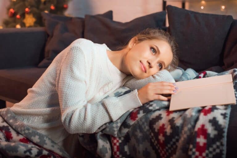 Woman relaxing with a journal during her evening routine for success, reflecting before bed for a calm and mindful end to the day.