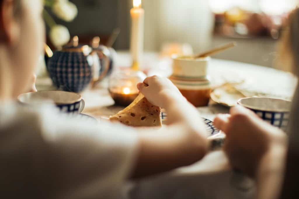 Mother and children enjoying a peaceful morning moment with tea during a mindful routine