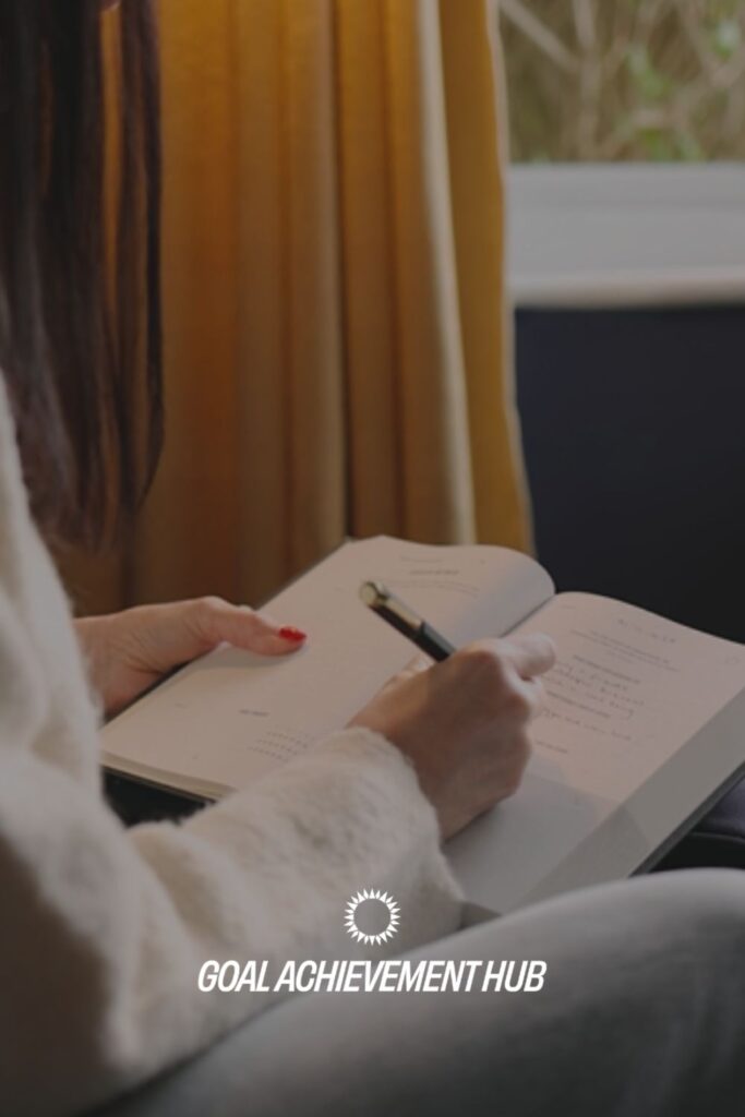 Person writing in a goal journal to reflect on habits and create a Stop-Doing List for better progress.
